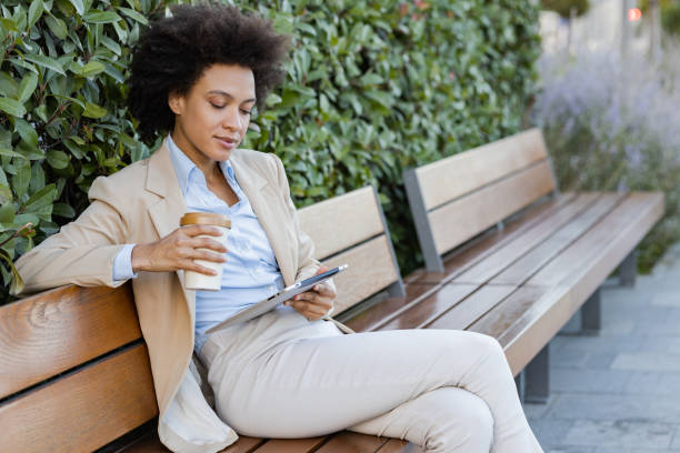istock Businesswoman relaxing outdoors and using digital tablet 1369759214