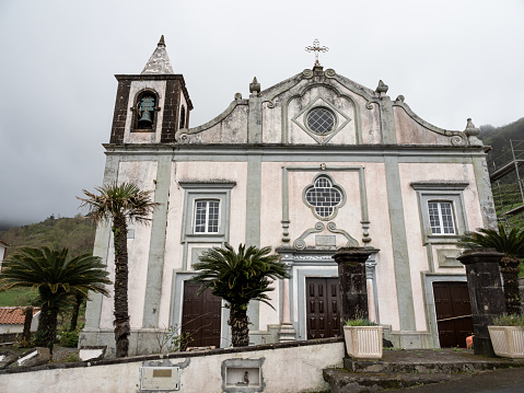 The facade of the Church of Nossa Senhora dos Remédios, the parish church of Fajãzinha, facade plastered and painted in white.\nLajes das Flores, Flores Island.