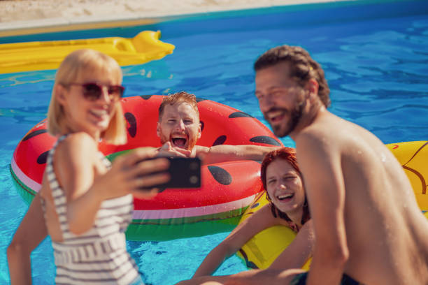 istock Friends taking a selfie at the swimming pool 1369761289