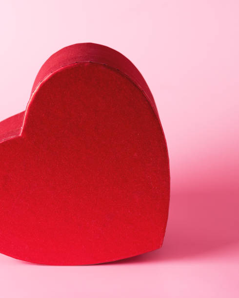 istock Heart Shaped Red Gift Box Valentine's day Background Empty Heart Shape Box on Pink Background Close Up 1369762465