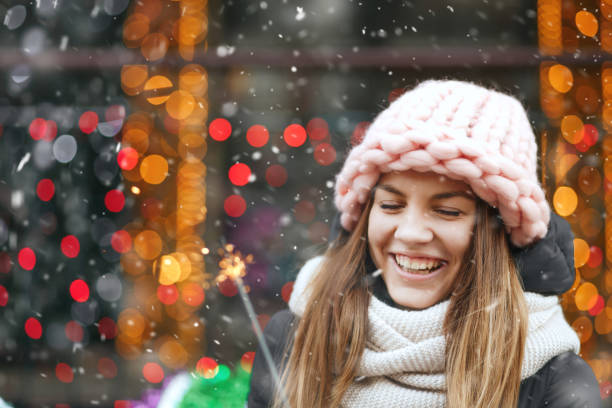 istock Cool lady playing with sparklers during the snowfall 1369762761