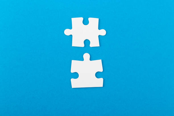 istock Jigsaw puzzle pieces on blue background. 1369763942