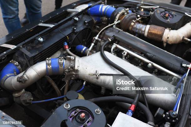 Sports Car Engine With Turbine An Open Race Car Hood On A Pit Stop While Racing On A Race Track Motor With Turbocharger Stock Photo - Download Image Now