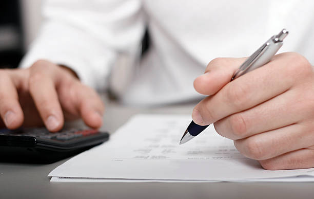 istock businessman calculating expenses at tax time 136976447