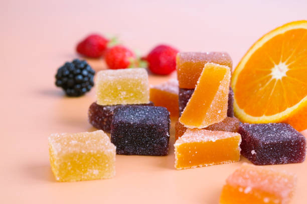 A colorful variety traditional French fruit jellies A colorful variety traditional French fruit jellies with fresh variant fruit as strawberry, blackberry and orange. The main ingredient are concentrate fruit paste, sugar and pectin dusting with sugar gummy candy photos stock pictures, royalty-free photos & images