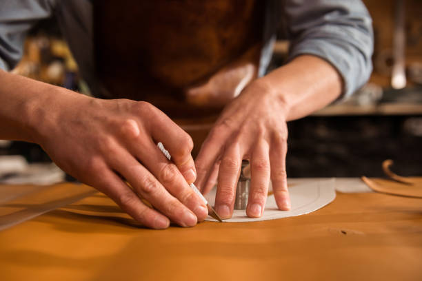 istock Close up of a shoemaker cutting leather 1369767064