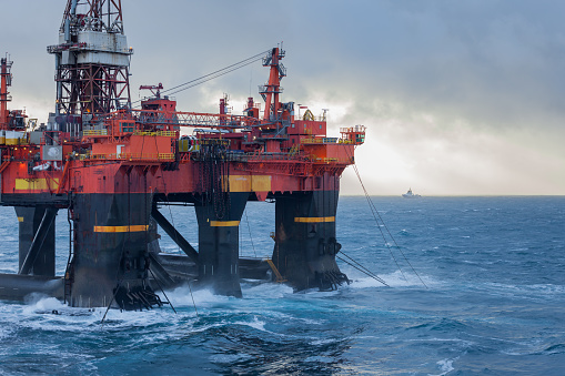 North Sea, Norway - 2016 January 11. Semi Submersible rig West Alpha deballasting and ready for rig move in Norwegian harsh weather condition