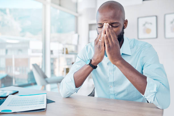 istock Shot of a young businessman looking stressed at work 1369768055