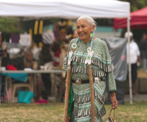 Pow Wow, Elder Jingle Dancer Gathering of First Nations at Oppenheimer Park, Vancouver, British Columbia, Canada on 9 September 2017. Pow Wows are opportunities for First Nations to gather, honouring and sharing their heritage and traditions including music, dance and beautifully vibrant regalia. The general public is welcome. dancing school stock pictures, royalty-free photos & images