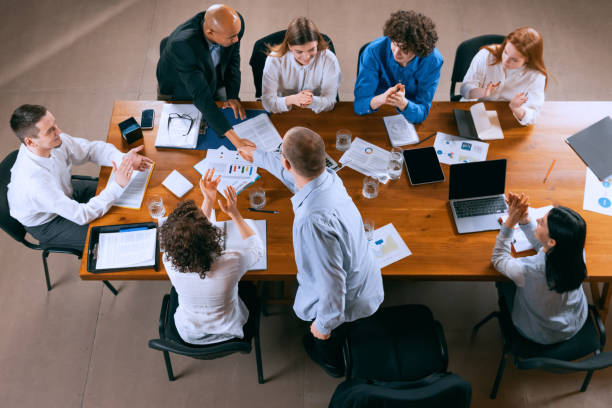 istock Top view of business conference, meeting. Young colleagues, co-workers, students during work process at office, indoors. Startup, finance, tech and innovation concept. 1369769431