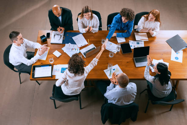 istock Aerial view of young multiethnic people talking, working with colleagues, co-workers at office, indoors. Work, finance, tech concept. 1369769433