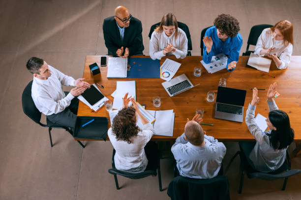 istock Top view of business conference, meeting. Young colleagues, co-workers, students during work process at office, indoors. Startup, finance, tech and innovation concept. 1369769457
