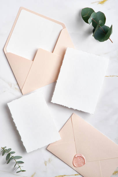 istock Wedding invitations and wedding stationery on stone table with eyucalyptus leaeves. Flat lay, top view. Minimnal style. 1369770138