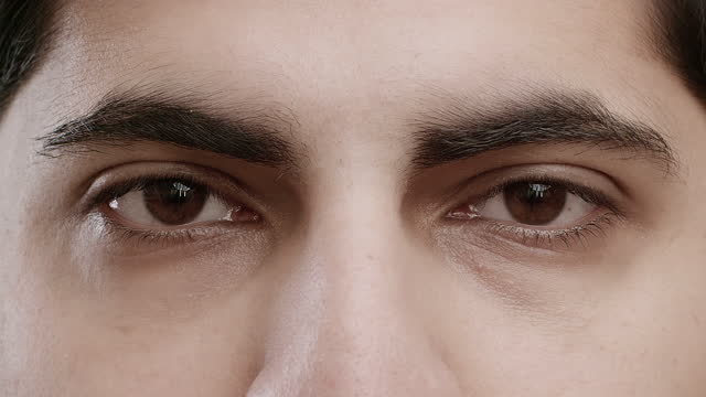 Sequence Of Diverse People's Eyes Looking At Camera In Studio