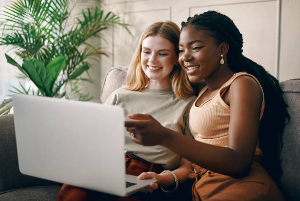 istock Shot of two young friends spending time together while using a laptop 1369773433