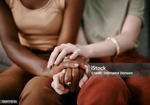Shot Of Two Friends Holding Hands Supporting One Another Stock Photo - Download Image Now