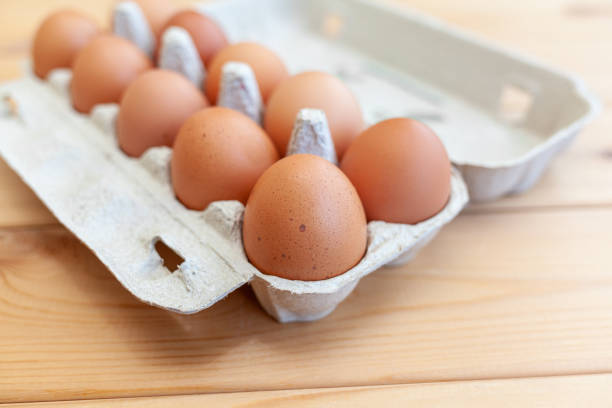 istock A few brown eggs among the empty cells of a large cardboard bag 1369773803