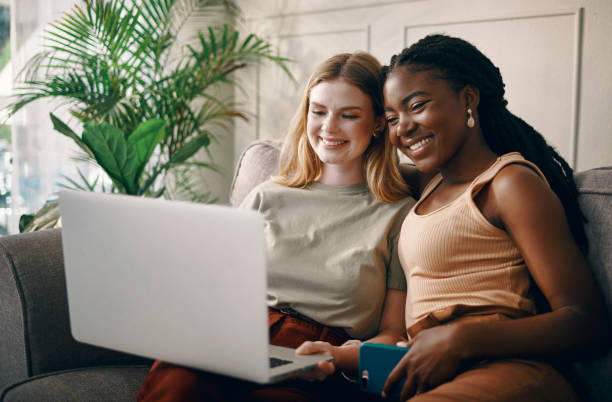istock Shot of two young friends spending time together while using a laptop 1369774156