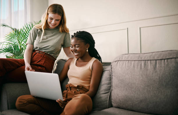 istock Shot of two young friends spending time together while using a laptop 1369774174