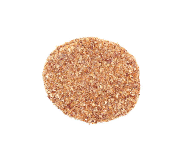 istock Raw burger cutlet isolated on white background. One breaded beef pattie. Top view. 1369775818