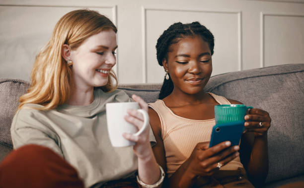 istock Shot of two friends catching up over coffee while using a smartphone 1369776057