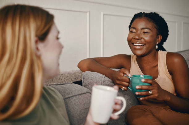 shot of two friends catching up over coffee - friendship cafe social gathering talking imagens e fotografias de stock