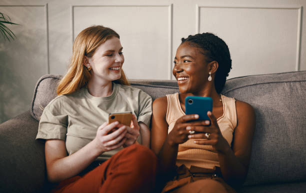 istock Shot of two friends relaxing while using a smartphone 1369776981