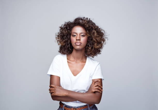 istock Confident young woman in white t-shirt 1369778599