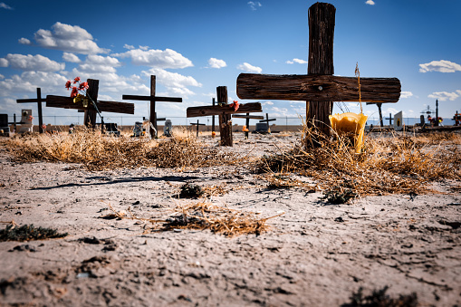 Desert graves with wooden crosses at a cemetery near El Paso, Texas.