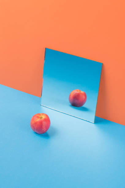 istock Apple on blue table isolated over orange background 1369781137