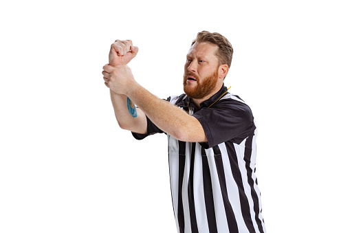 Referee either pointing up to copy space or saying number one team