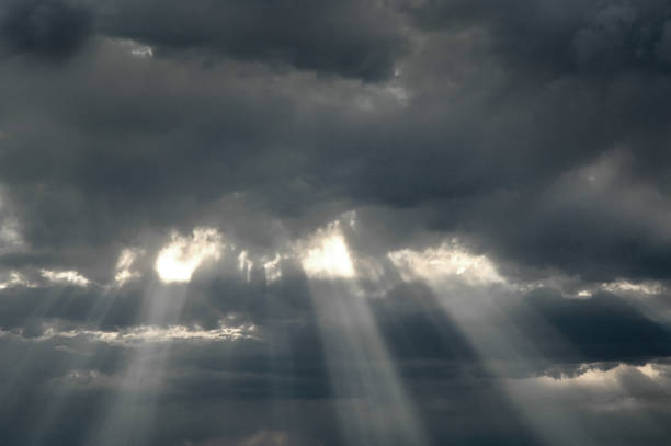 istock Rays of Sunlight in Storm Clouds for Hope and Faith 1369782518