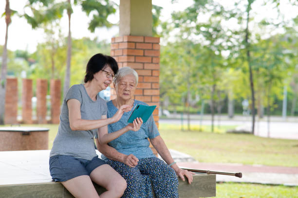 istock Senior Asian mother learning new technology in the park 1369783134