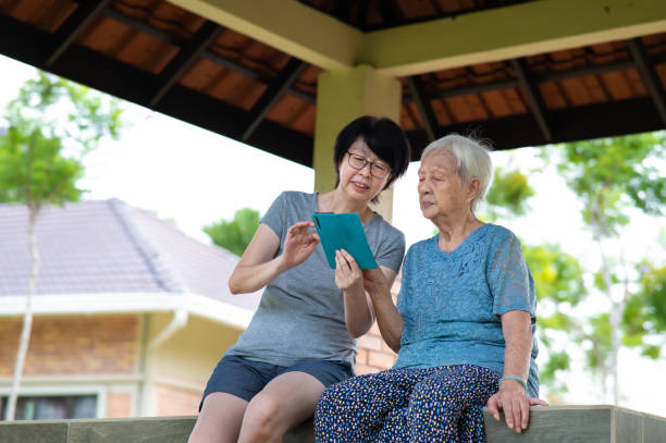 istock Senior Asian mother learning new technology in the park 1369783146