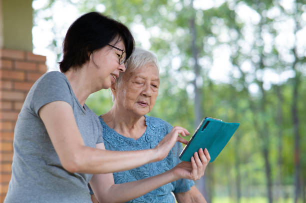 istock Senior Asian mother learning new technology in the park 1369783150