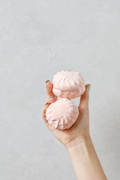 istock Marshmallow - zephyr on a light background. Confectionery concept. 1369783200