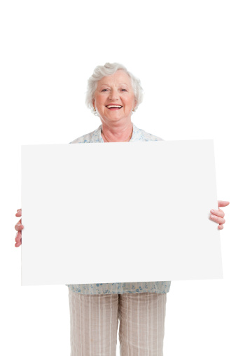 Happy smiling senior woman holding blank placard to write it on your own text, isolated on white background.