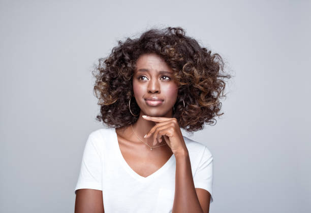 istock Thoughtful young woman in white t-shirt 1369786021