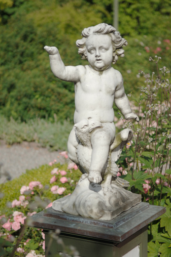 Angel in the cemetery monument at the grave of a child sculpture in the form of an angel.