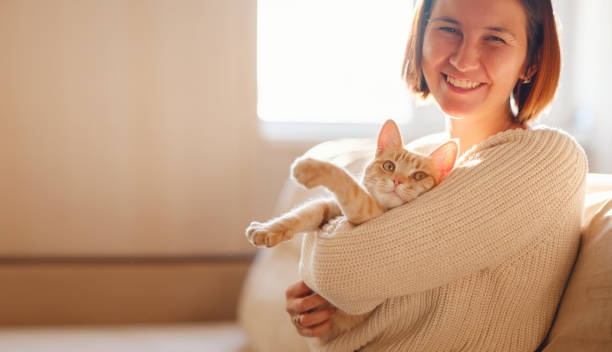 istock woman resting with cat on sofa at home 1369789767