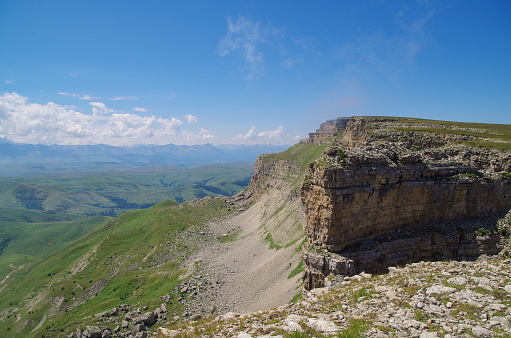 Amazing view from the Malyy Bermamyt Plateau. Green valley and mountain chains of the Greater Caucasus. Nature and travel. Russia, Caucasus, Karachay-Cherkessia