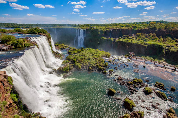View of the Iguazu Falls, border between Brazil and Argentina. View of the Iguazu Falls, border between Brazil and Argentina. The falls are one of the seven wonders of the world and are located in the Iguaçu National Park, a UNESCO World Heritage Site. southern brazil photos stock pictures, royalty-free photos & images