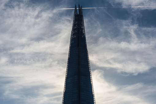 Tower and cross of an orthodox church against the blue sky on a sunny day.