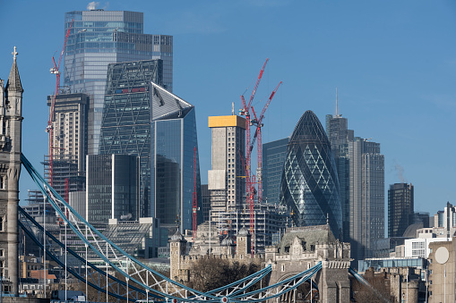 A view of London's developing financial district with modern glass skyscrapers on a beautiful sunny day.