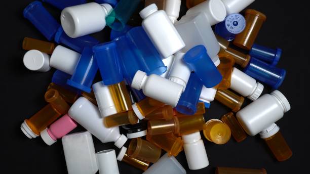 istock Medical waste. Empty pills bottles or packs for medications. Disposing empty medication containers made of plastic. Hospital waste. Pharmaceutical industry. Overbooked hospitals treatments. 1369794146