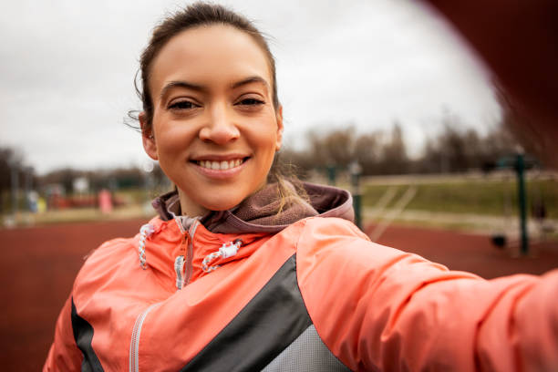 istock Young woman making a selfie ,looking at camera 1369794779