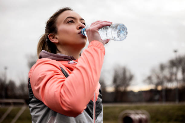 istock Young woman Drinking Water after workout 1369794823