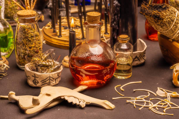 istock Witchcraft table set, selective focus. Alchemy and esoteric symbol items for magic cult. Spiritual occultism and magic chemistry inspired by mysticism. Witch and warlock magician concept. Halloween. 1369795844