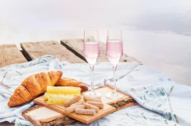 istock romantic picnic by the water with champagne, sweets and cheese 1369796964