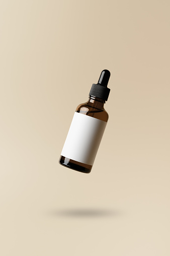 Brown dropper glass bottle flying in antigravity on pastel beige background. Levitation object in the air. Skincare concept. Organic natural cosmetic product. Mockup, minimal style
